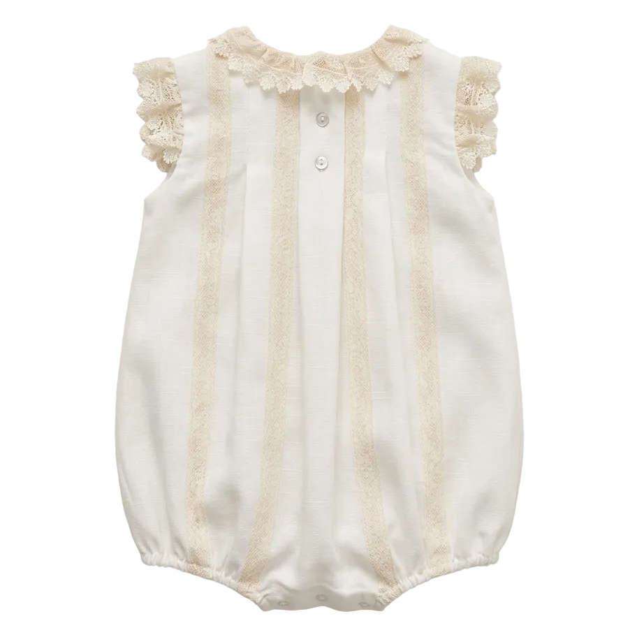 White baby romper with lace details on a white background